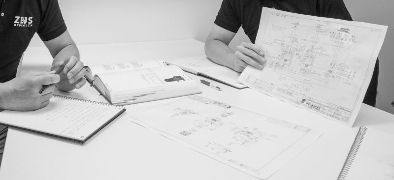 Zeus Hydratech's engineers consulting over hydraulic power pack design.